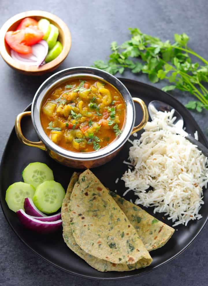Ridge Gourd Curry or Turai ki subii served with roti, rice and salad in a plate