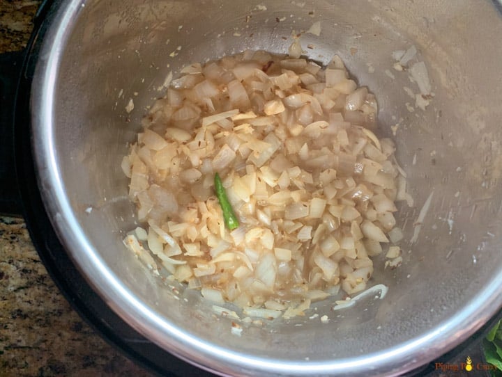 In instant pot, showing onions sautéed for about 3 minutes.