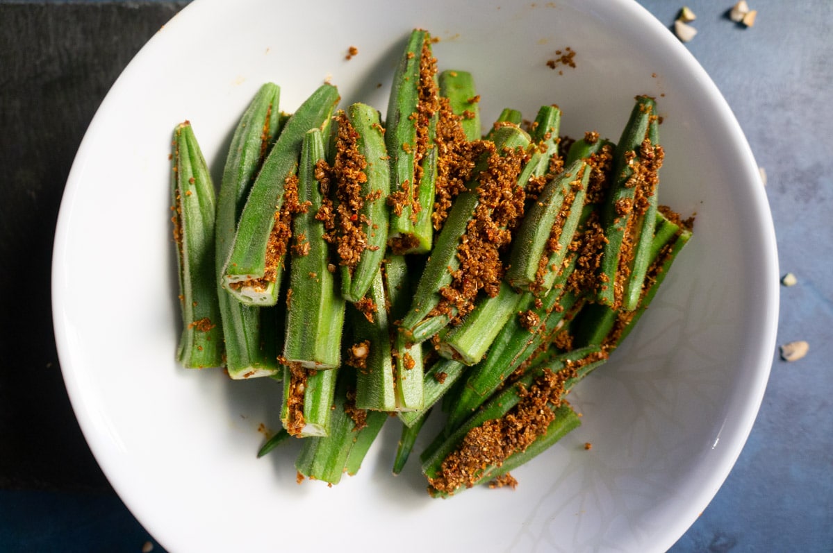 Okra stuffed with spices in a white bowl
