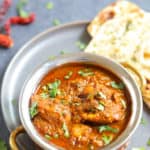 Authentic Chicken Vindaloo served in a bowl along with naan bread