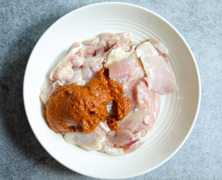Chicken Vindaloo in Instant Pot - Piping Pot Curry-11 Vindaloo Curry Sauce added to cubed chicken thighs