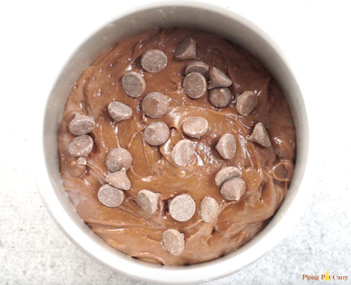Brownie batter topped with chocolate chips ready to be cooked in the instant pot.