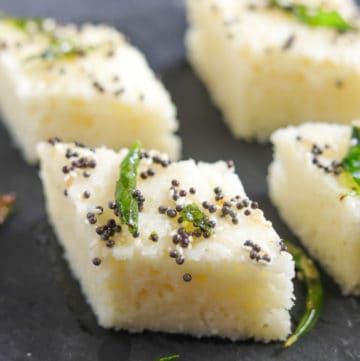 Rava Dhokla (Savory Semolina Cakes) made in the instant pot, served with tempering on a snack plate