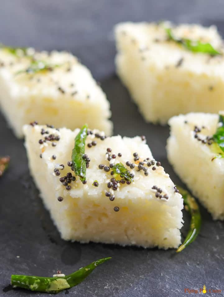 Rava Dhokla (Savory Semolina Cakes) made in the instant pot, served with tempering on a snack plate