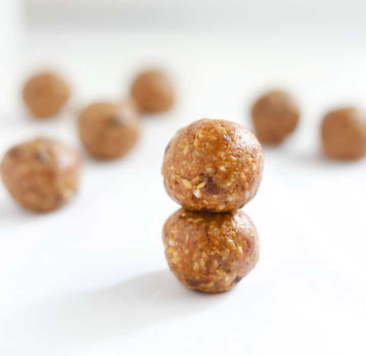 Almond Butter Date Energy Bites - rolled into balls and laid out on a white board