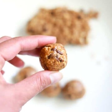 Almond Butter Date Energy Ball closeup in between fingers