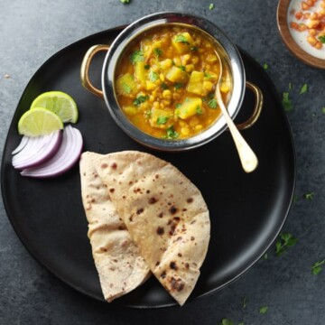 Lauki Chana Dal served with roti and onions, lime.