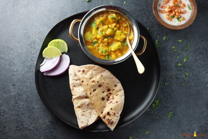 Lauki Chana Dal served with roti and onions, lime.