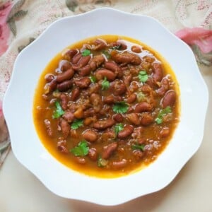 Rajma (Red Beans Curry) garnished with cilantro served in a white bowl