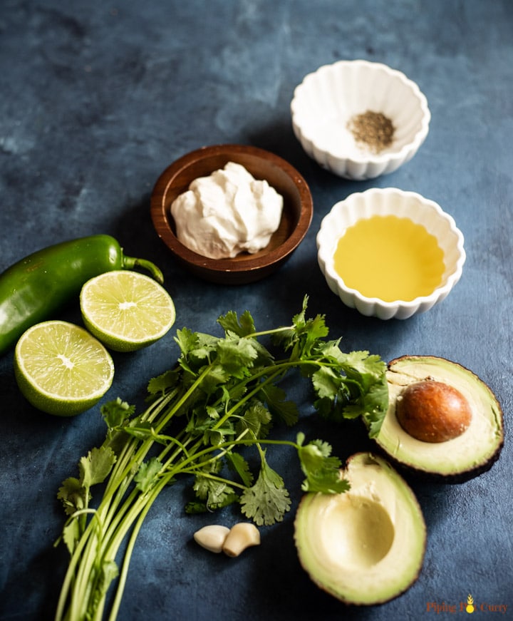 Ingredients such as avocado, jalapeño, cilantro, garlic, lime, salt, pepper