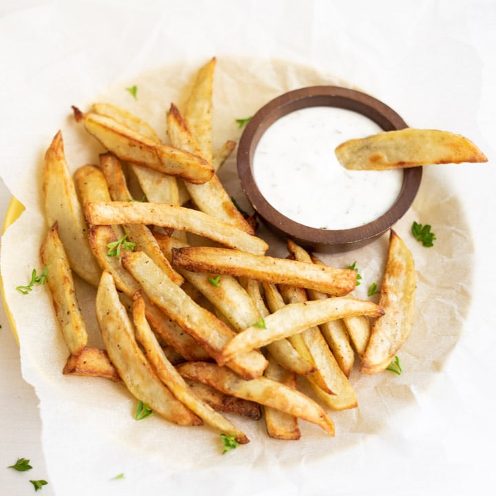 crispy French fries in a plate served with a dip