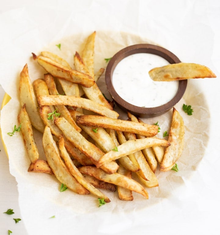 Crispy French Fries with a white yogurt dipping sauce 