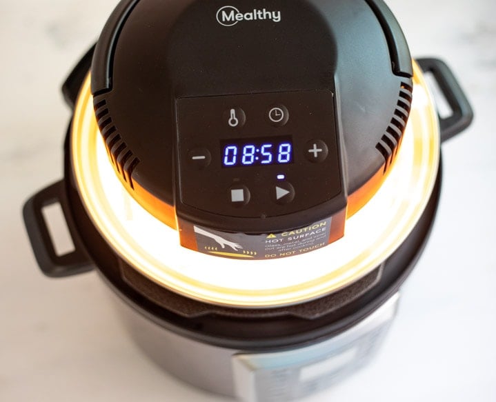 Mealthy Crisplid on top of the electric pressure cooker