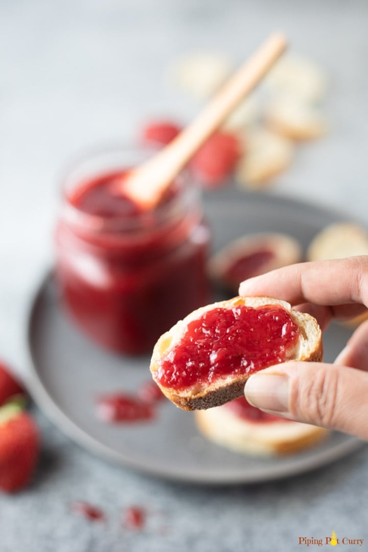 Closeup of a sliced bread topped with strawberry jam