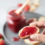 Closeup of a sliced bread topped with strawberry jam