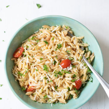 Lemon Parmesan Orzo with tomatoes in a green bowl