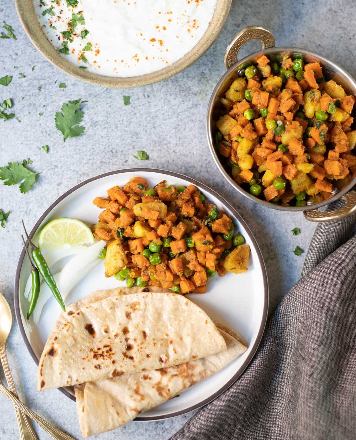 Aloo Gajar Matar served in a plate with roti