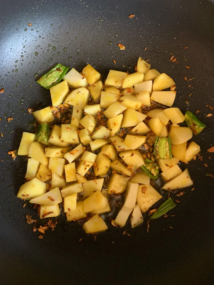 Aloo Gajar Matar-step 2 Cooking potatoes to a wok
