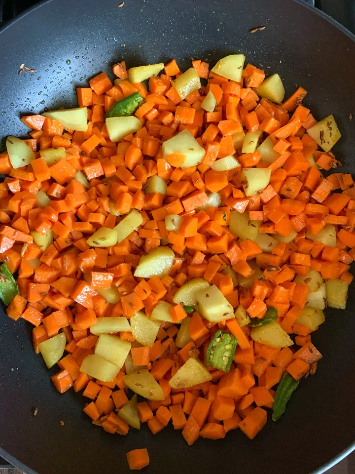 Aloo Gajar Matar-step 3 Cook carrots and potatoes in a wok