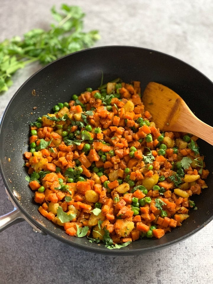 Potato, Carrots and Peas Curry (Aloo Gajar Matar) curry cooked in a wok