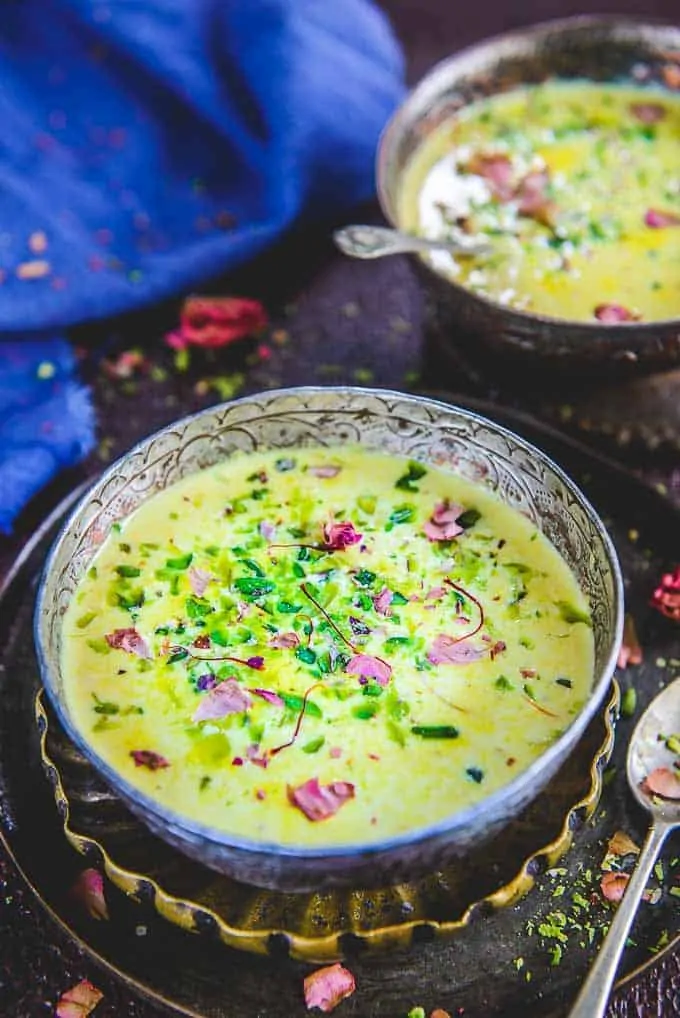 Basundi topped with rose petals in a bowl