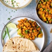 Aloo Gajar Matar served in a plate with roti