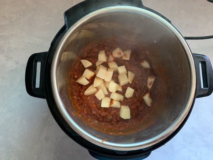 Vegetable Korma in Instant Pot - Step 4 Piping Pot Curry Add potatoes to the curry