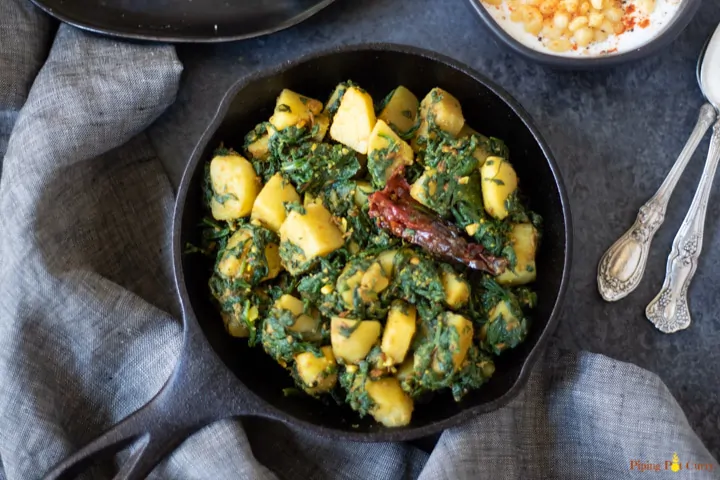 Aloo Palak (Potato Spinach curry) in a cast iron pan. 