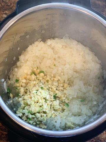 Onions with minced ginger , garlic and green chili pepper in the pressure cooker