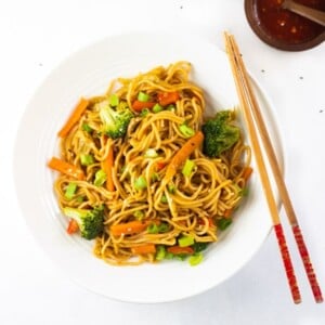 Chinese noodles in a serving plate with wooden chopsticks