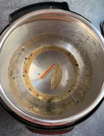 Instant Pot Vegetable Biryani Steps - Piping Pot Curry-2 Whole spices being sautéed in instant pot