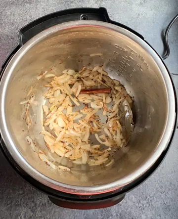 Instant Pot Vegetable Biryani Steps - Piping Pot Curry-4 Saute onions and whole spices in pressure cooker