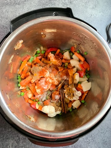 Vegetables topped with spices in an instant pot