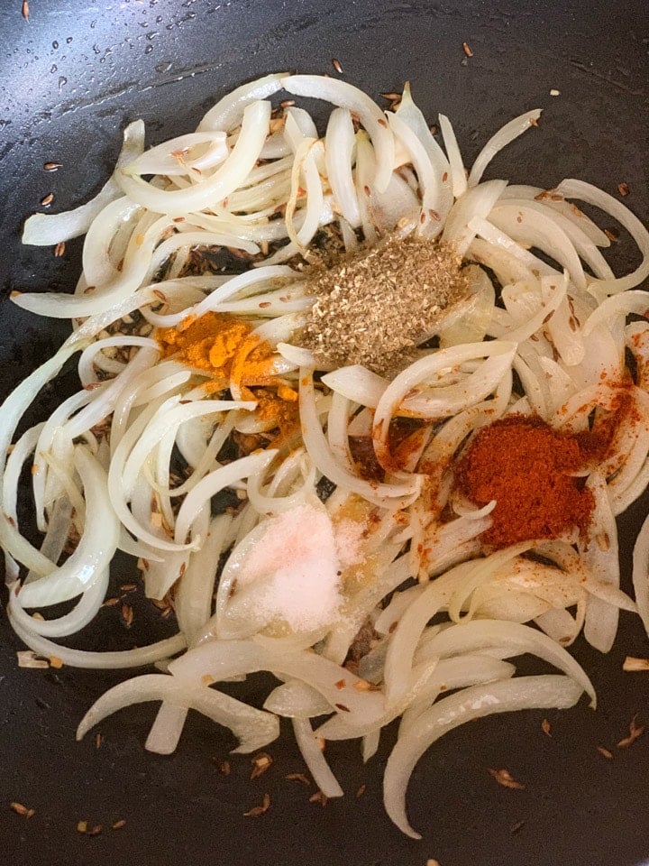 Paneer Jalfrezi step 1 - Piping Pot Curry Onions with spices in a pan