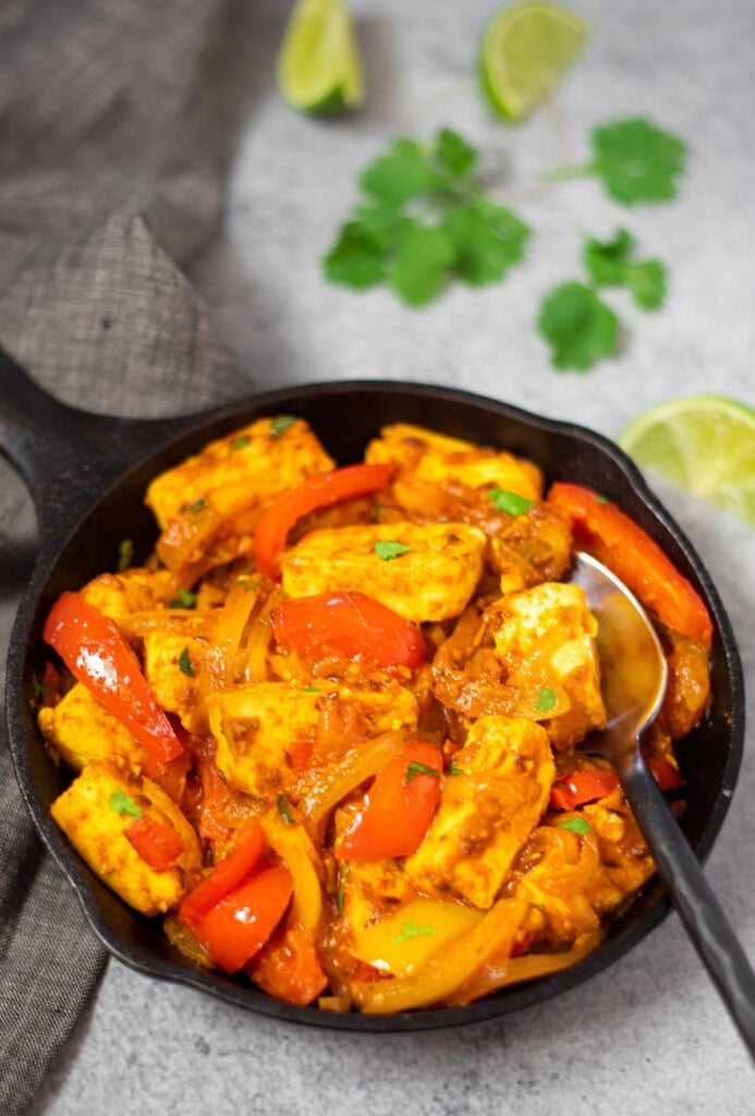 Paneer jalfrezi in a skillet garnished with cilantro 