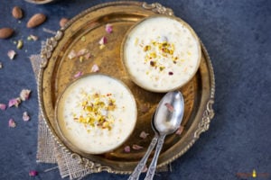 Sabudana Kheer in two bowls garnished with nuts and rose petals