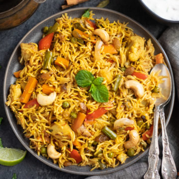 Vegetable Biryani Rice garnished with mint leaves and roasted nuts