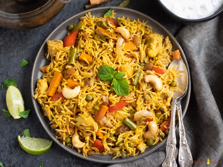 Vegetable Biryani Rice garnished with mint leaves and roasted nuts