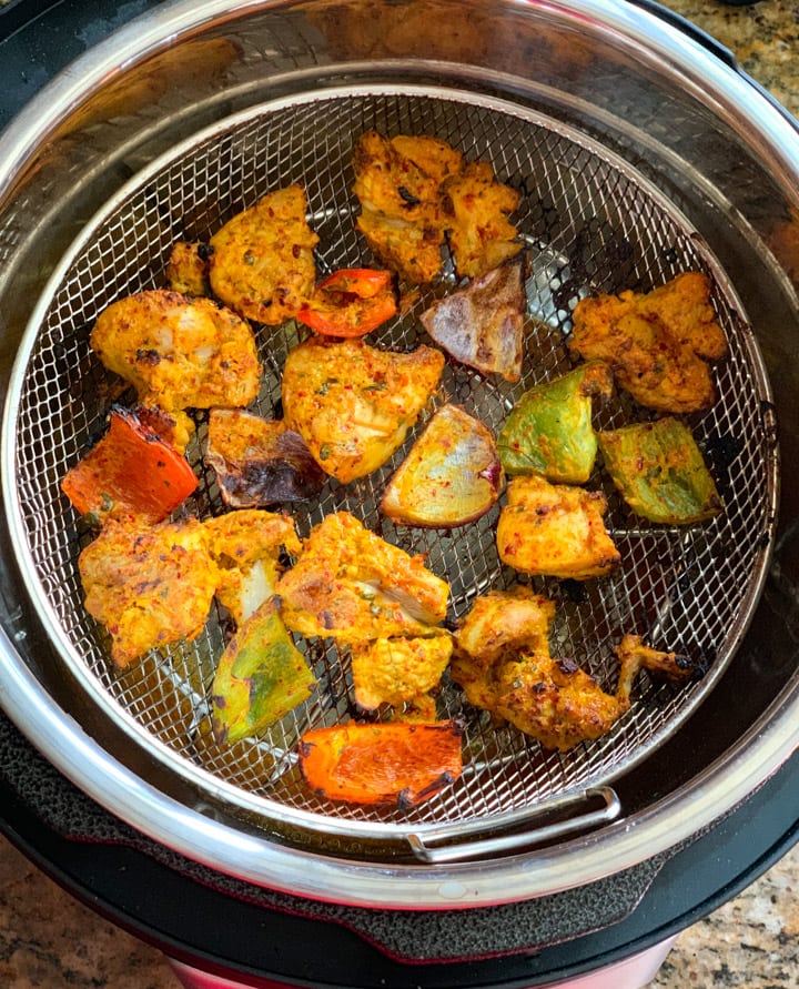 Chicken Tikka Bites Instant Pot Crisplid - Piping Pot Curry Cooked chicken tikka bites in a air fryer attachment for pressure cooker