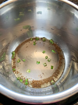 Cumin and green chili in oil in instant pot