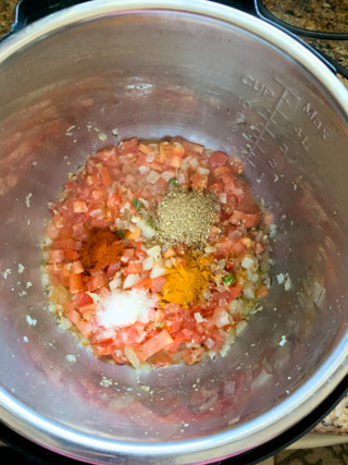 Onions, Tomatoes and spices being cooked in instant pot