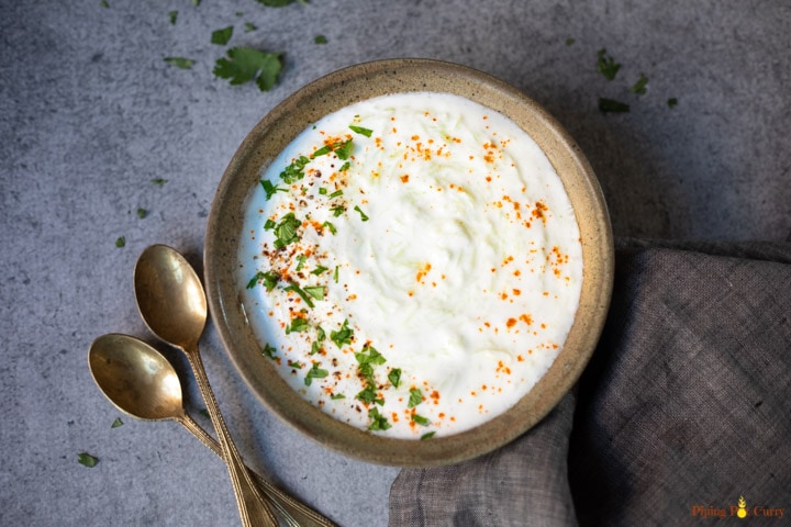 Yogurt with bottle gourd garnished with cilantro and red chili powder