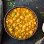 Green Peas and Foxnuts curry (Matar Makhana) in a bowl with 2 spoons