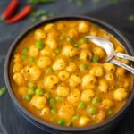 Green Peas and Foxnuts curry (Matar Makhana) in a bowl with 2 spoons