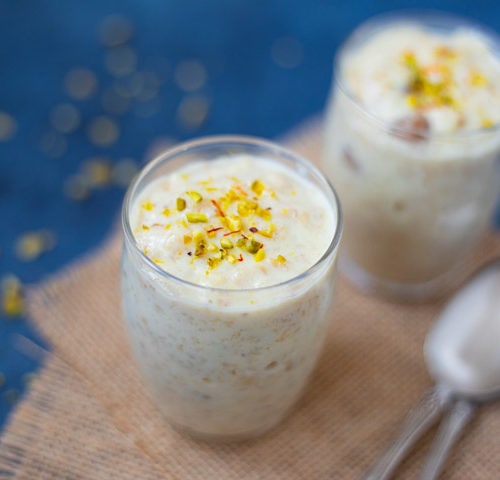 Indian Rolled Oats Kheer topped with pistachios and saffron in 2 small glasses