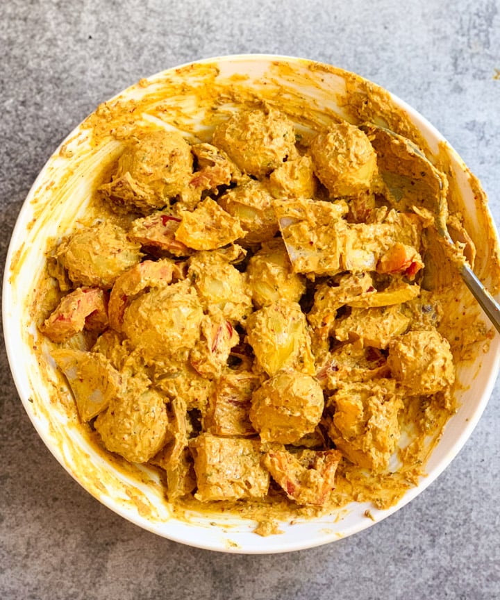 Marinated Tandoori Aloo Tikka - Piping Pot Curry Marinated potatoes and veggies in a white bowl