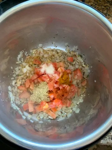 Onions, tomatoes and spices for tempering in the instant pot