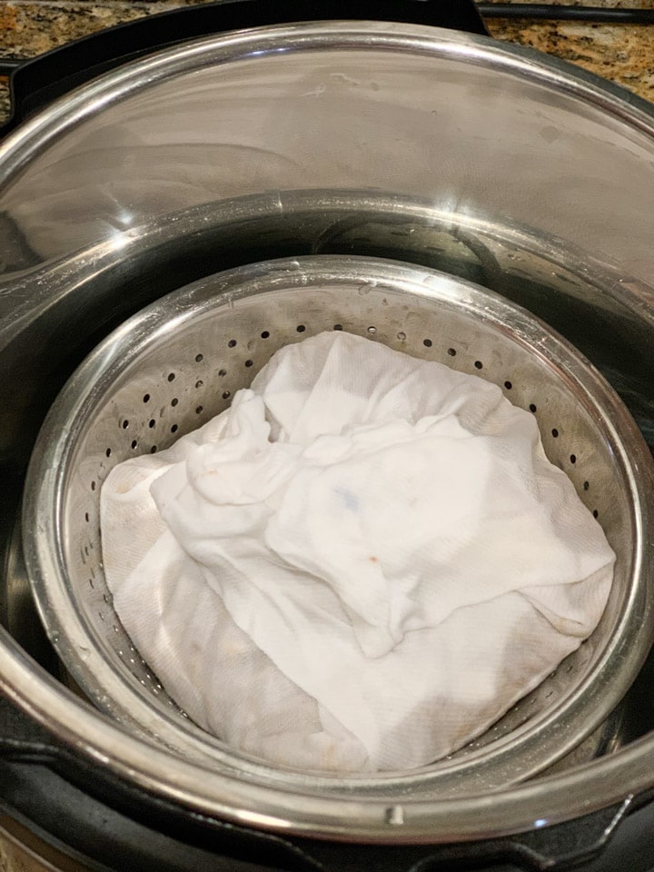 Cheesecloth with chickpeas in a colander in the instant pot