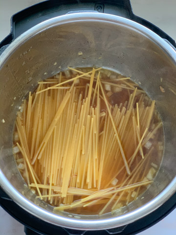 creamy mushroom pasta instant pot steps - Piping Pot Curry-5 Spaghetti in broth in the instant pot ready to be cooked