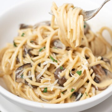 creamy mushroom spaghetti in a white bowl